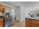 Bright kitchen with hardwood floors, stainless steel refrigerator, and ample cabinet space at 206 Black Bird Ct, Cary, NC 27511