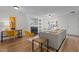 Open-concept living room featuring hardwood floors, fireplace, a work station, and a neutral color palette at 206 Black Bird Ct, Cary, NC 27511