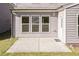 Cozy back patio with three windows and a door offering plenty of natural light and easy access at 2221 Holtwood Way, Apex, NC 27523
