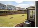 Large backyard with lush lawn, tree, and retaining wall offering privacy and scenic views at 2221 Holtwood Way, Apex, NC 27523