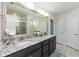 Bathroom featuring granite countertops, dual sinks, large mirror, modern vanity lighting, and tiled floors at 2221 Holtwood Way, Apex, NC 27523
