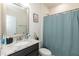 Bathroom featuring a vanity with granite countertop and a shower with a blue shower curtain at 2221 Holtwood Way, Apex, NC 27523
