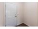 Clean, bright entrance with white door, baseboards, and wood flooring at 2221 Holtwood Way, Apex, NC 27523