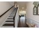 Inviting entryway featuring a staircase with dark wood steps and white risers and an open view to the living area at 2221 Holtwood Way, Apex, NC 27523