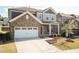 Charming two-story home with stone accents, a two-car garage, and a beautifully landscaped front yard at 2221 Holtwood Way, Apex, NC 27523