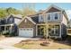 Charming two-story home with stone accents, a two-car garage, and a beautifully landscaped front yard at 2221 Holtwood Way, Apex, NC 27523