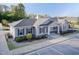 Exterior view of a beautifully landscaped community clubhouse, featuring complementary hardscaping and parking at 2221 Holtwood Way, Apex, NC 27523