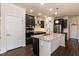 Well-appointed kitchen with stainless steel appliances, a central island with a granite countertop, and custom cabinetry at 2221 Holtwood Way, Apex, NC 27523