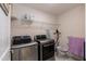Laundry room with newer washer/dryer, wire shelves, and modern convenience at 2221 Holtwood Way, Apex, NC 27523