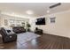 Spacious living room with a large TV, comfortable leather seating, and plenty of natural light at 2221 Holtwood Way, Apex, NC 27523