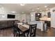 Open-concept living room and kitchen with dark wood floors and stainless steel appliances for modern living at 2221 Holtwood Way, Apex, NC 27523