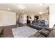 Open concept living room flows into kitchen, featuring a plush gray sofa and stylish decor at 2221 Holtwood Way, Apex, NC 27523