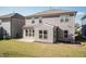Rear view of a two-story home showcasing siding, windows, and a small patio area at 2221 Holtwood Way, Apex, NC 27523