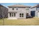 Back of the house showcasing the patio, siding, and windows with an expansive yard at 2221 Holtwood Way, Apex, NC 27523
