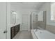 Bright bathroom featuring a soaking tub, shower and vanity with dual sinks at 2227 Rocky Bay Ct, Cary, NC 27519
