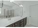 Bathroom with large mirror, vanity with dual sinks, and walk-in shower at 2227 Rocky Bay Ct, Cary, NC 27519