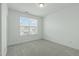 Bright bedroom features plush carpeting, neutral walls, and a window with exterior view at 2227 Rocky Bay Ct, Cary, NC 27519