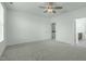 Spacious bedroom with light-colored carpet, white walls and a ceiling fan at 2227 Rocky Bay Ct, Cary, NC 27519