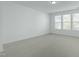 Bright bedroom features plush carpeting, neutral walls, and plenty of natural light from the windows at 2227 Rocky Bay Ct, Cary, NC 27519