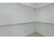 Empty walk-in closet with white walls and wooden shelving at 2227 Rocky Bay Ct, Cary, NC 27519