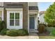The welcoming entrance boasts a stylish front door, manicured bushes and a well-maintained lawn at 2227 Rocky Bay Ct, Cary, NC 27519