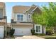 This home offers a two-car garage with a long driveway and a beautifully landscaped yard with mature trees at 2227 Rocky Bay Ct, Cary, NC 27519