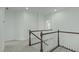 Hallway with white walls, trim and carpet. Stairs with white rails and dark wood banister at 2227 Rocky Bay Ct, Cary, NC 27519