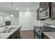 Updated kitchen featuring stainless steel appliances and granite countertops at 2227 Rocky Bay Ct, Cary, NC 27519