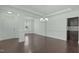 Open-concept living space featuring hardwood floors, elegant lighting, and access to the kitchen at 2227 Rocky Bay Ct, Cary, NC 27519
