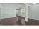 Open concept living area featuring hardwood floors, large windows, and elegant lighting fixtures at 2227 Rocky Bay Ct, Cary, NC 27519