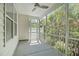 Relaxing screened porch with fan, white walls and great views of backyard trees and greenery at 2227 Rocky Bay Ct, Cary, NC 27519