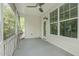 Relaxing screened porch features white walls, fan, access to the yard and back door at 2227 Rocky Bay Ct, Cary, NC 27519