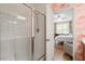 View of the bedroom from the bathroom featuring a glass-door shower at 225 Mayfield Dr, Apex, NC 27539