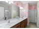 Bathroom features a double sink vanity, large mirror, and shower at 225 Mayfield Dr, Apex, NC 27539