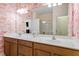Bright bathroom with double sinks, decorative wallpaper, and a large mirror at 225 Mayfield Dr, Apex, NC 27539