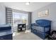 Charming Bedroom with a blue crib and plentiful natural light from a large window at 225 Mayfield Dr, Apex, NC 27539