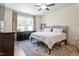 Bright bedroom featuring a ceiling fan, large window, and patterned area rug at 225 Mayfield Dr, Apex, NC 27539