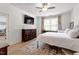 Bedroom with ceiling fan, large window, dresser and TV at 225 Mayfield Dr, Apex, NC 27539