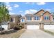Charming two-story townhome with an attached two car garage and an inviting facade with red shutters at 225 Mayfield Dr, Apex, NC 27539