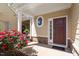 Cozy front porch with beautiful stone and a pop of color with the front rose bushes at 225 Mayfield Dr, Apex, NC 27539