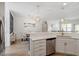 Open kitchen view with stainless appliances, quartz countertops, and modern pendant lighting at 225 Mayfield Dr, Apex, NC 27539