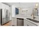Modern kitchen showcasing stainless steel appliances, quartz countertops, and an open floor plan at 225 Mayfield Dr, Apex, NC 27539