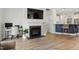 Living room with fireplace, built-in shelves, and seamless flow into the kitchen area at 225 Mayfield Dr, Apex, NC 27539