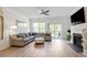 Cozy living room features hardwood floors, a fireplace, and a sliding glass door to the backyard at 225 Mayfield Dr, Apex, NC 27539