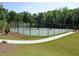Community tennis court surrounded by lush greenery, perfect for active recreation at 225 Mayfield Dr, Apex, NC 27539