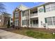 Charming townhome exterior featuring private balconies, well-kept landscaping, and building address markers at 2421 Kudrow Ln, Morrisville, NC 27560