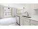 Modern kitchen with stainless steel appliances, double sink, and open view to the living area at 2421 Kudrow Ln, Morrisville, NC 27560