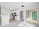 Bright kitchen with stainless steel appliances, white cabinetry, and convenient access to the living area and patio at 2421 Kudrow Ln, Morrisville, NC 27560