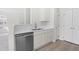 Modern kitchen featuring stainless steel appliances and bright cabinets, with an open layout at 2421 Kudrow Ln, Morrisville, NC 27560