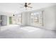 Bright living area featuring plush carpeting, abundant natural light, and easy access to an outdoor patio at 2421 Kudrow Ln, Morrisville, NC 27560